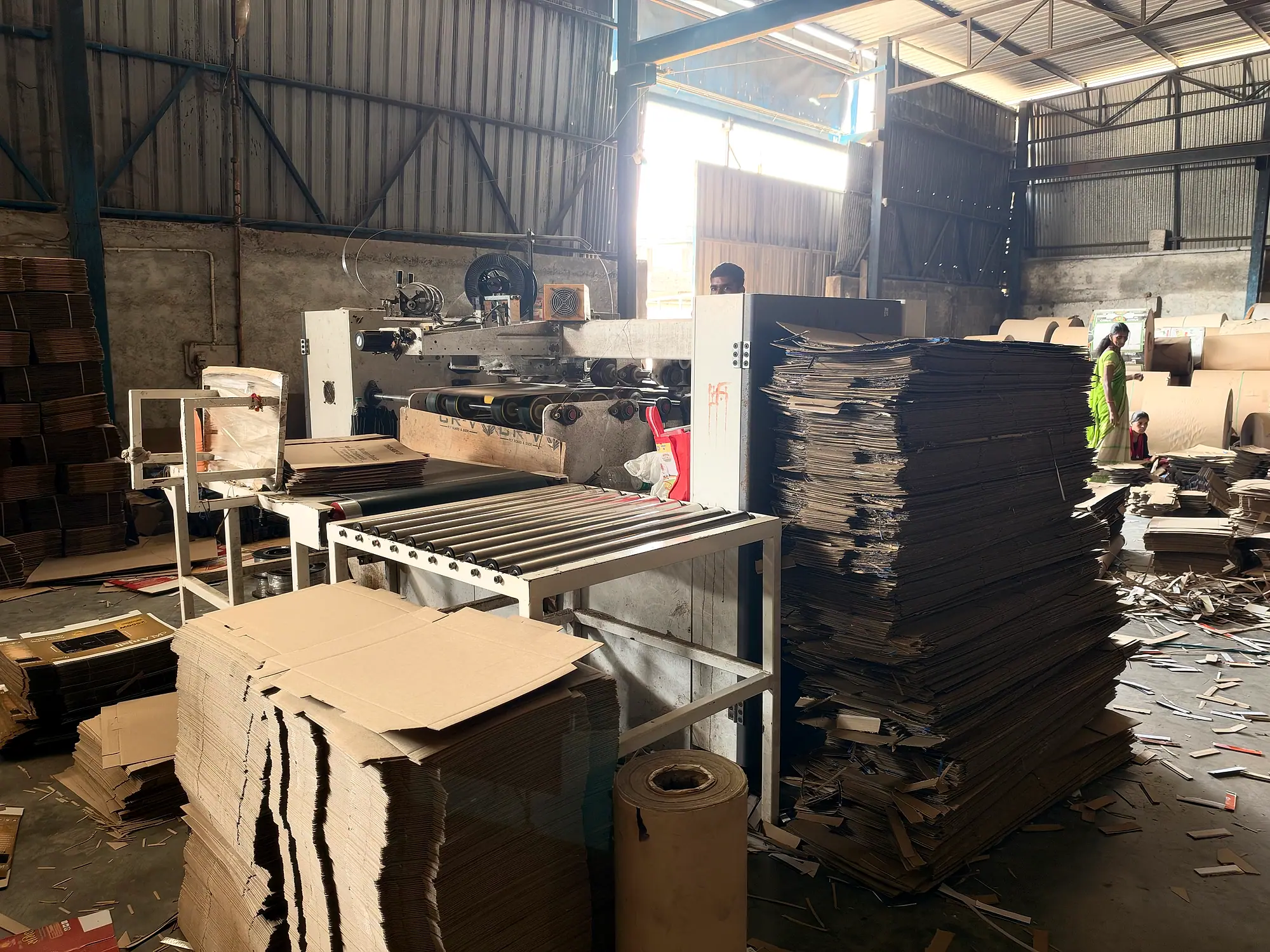 FIDVI Industries corrugated box factory floor in Ujjain, Madhya Pradesh, with board stacks