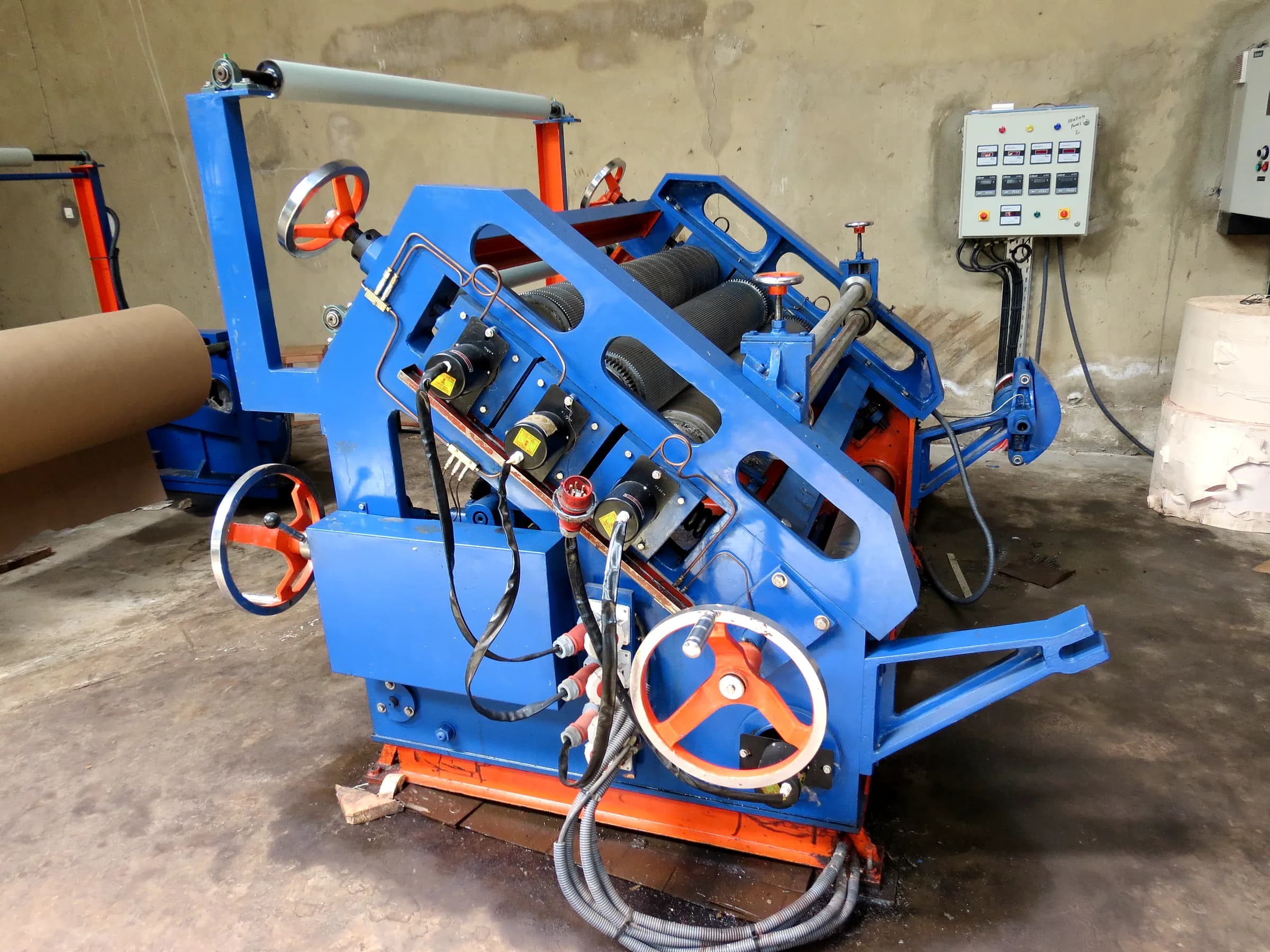 Interior of a packaging production hall with paper reels and machinery